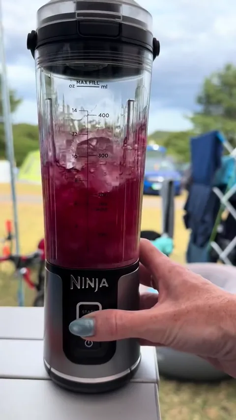 The blender running on the camping table.